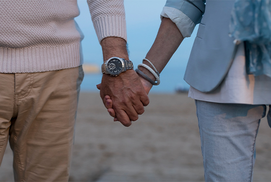 close up of couple holding hands on the beach annuities for retirement houston tx